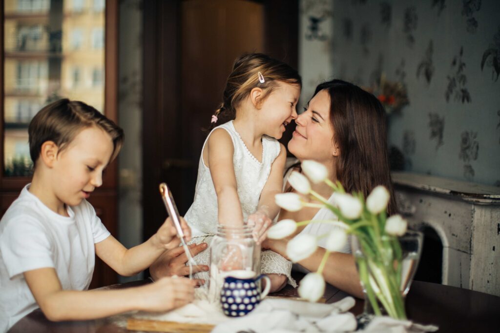 A mother happy doing kitchen activities with her children