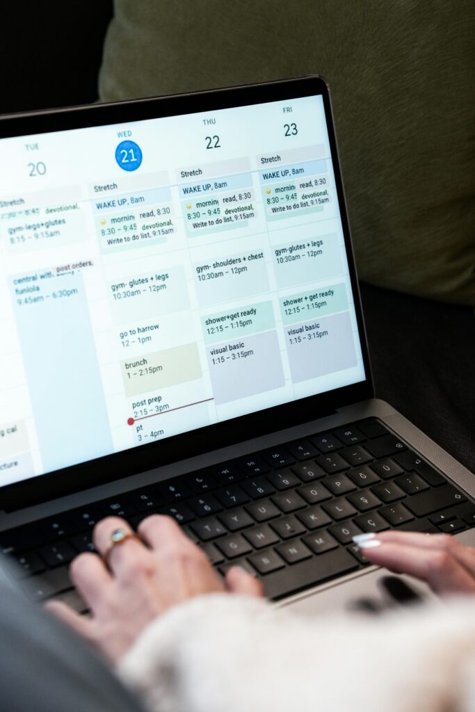 A woman writing in a planner at a calm uncluttered workspac